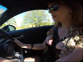 British mature Red fingers her cunt in the car again